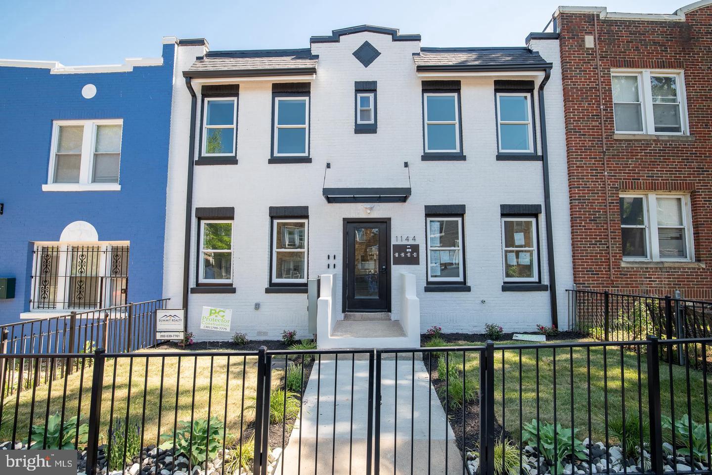 1144 Owen Place Northeast, Unit 1 Washington, DC 20002 - Photo 3 of 27 a front view of a house with a garden