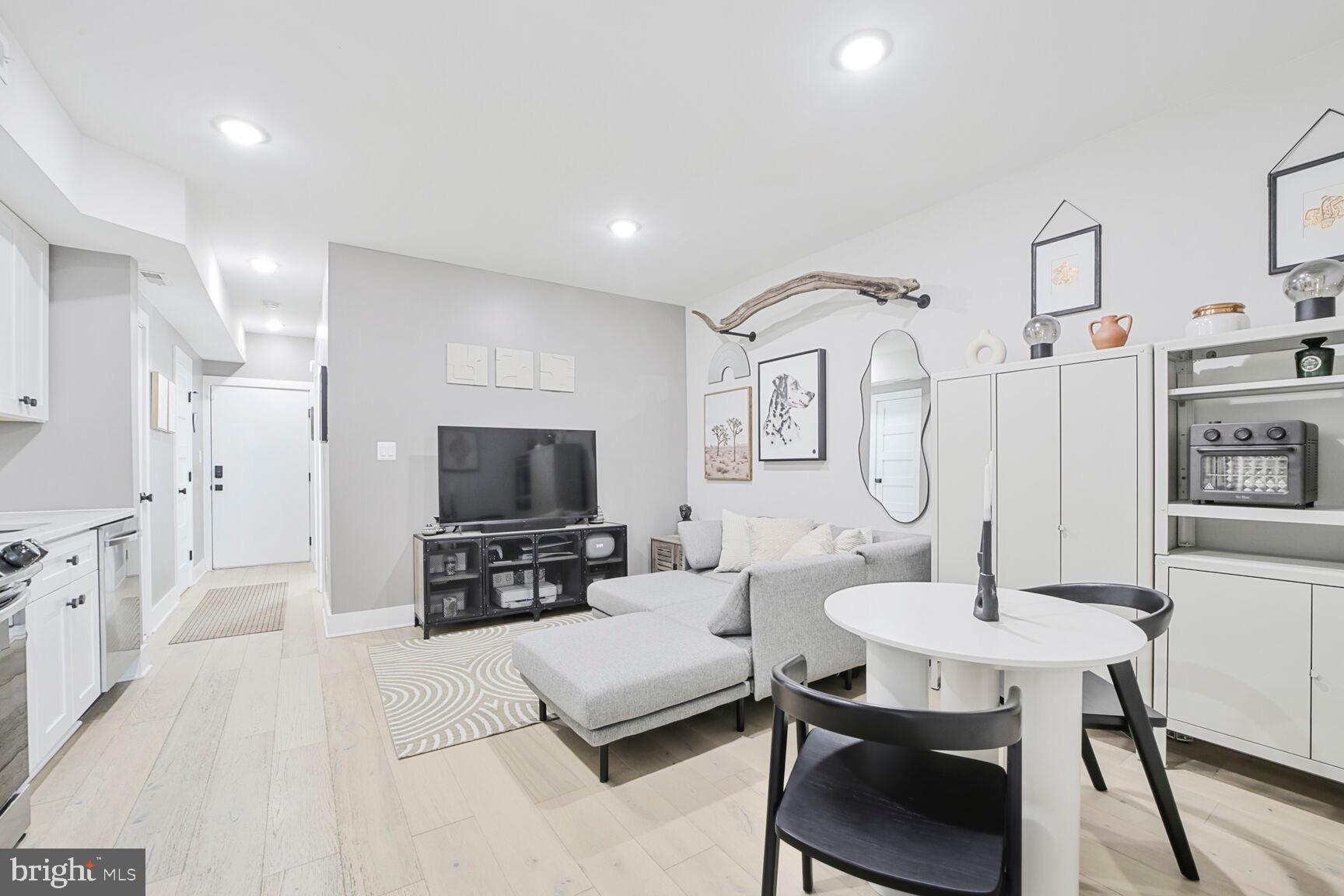 1144 Owen Place Northeast, Unit 1 Washington, DC 20002 - Photo 4 of 27 a living room with furniture and a flat screen tv