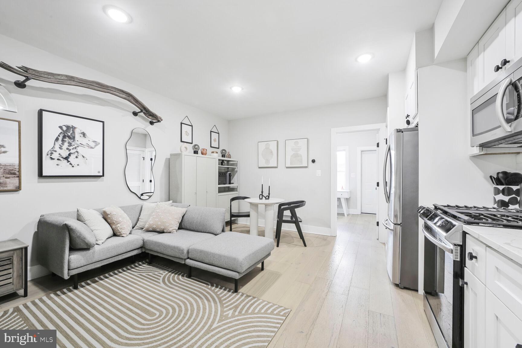 1144 Owen Place Northeast, Unit 1 Washington, DC 20002 - Photo 5 of 27 a living room with furniture and a wooden floor