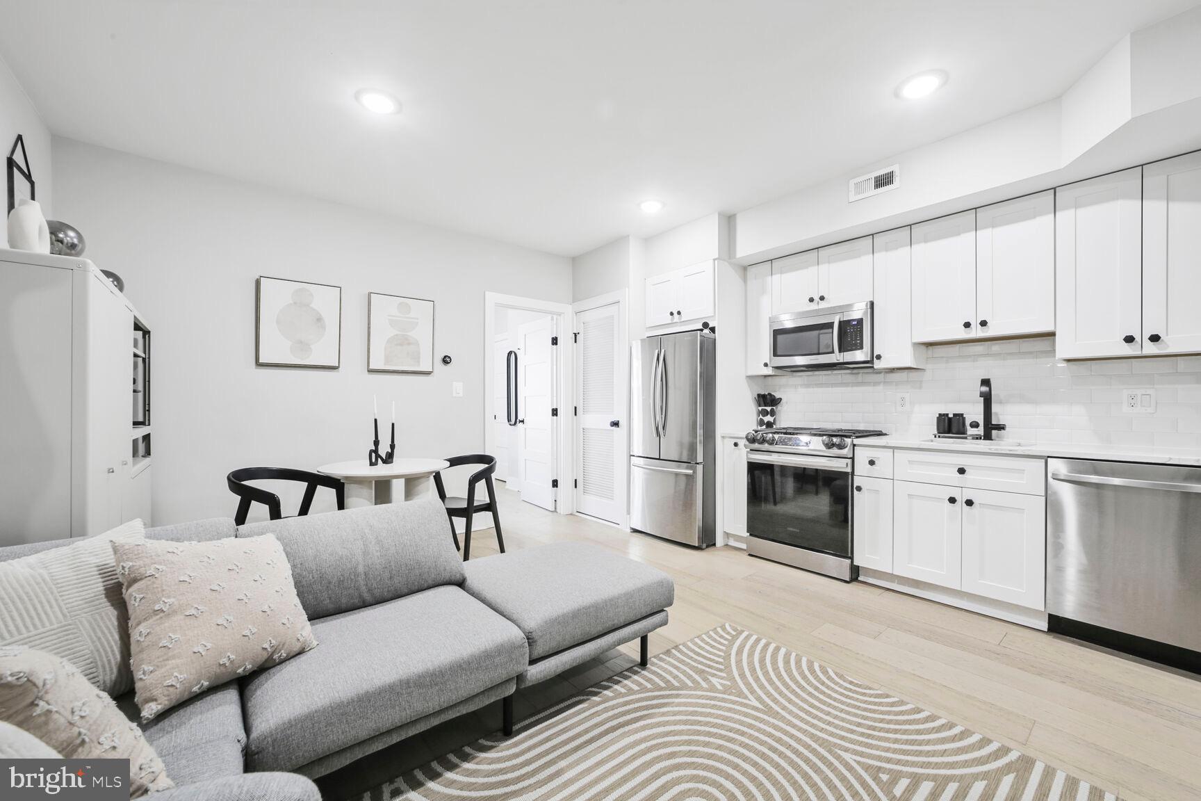 1144 Owen Place Northeast, Unit 1 Washington, DC 20002 - Photo 6 of 27 a living room with furniture white walls and white appliances