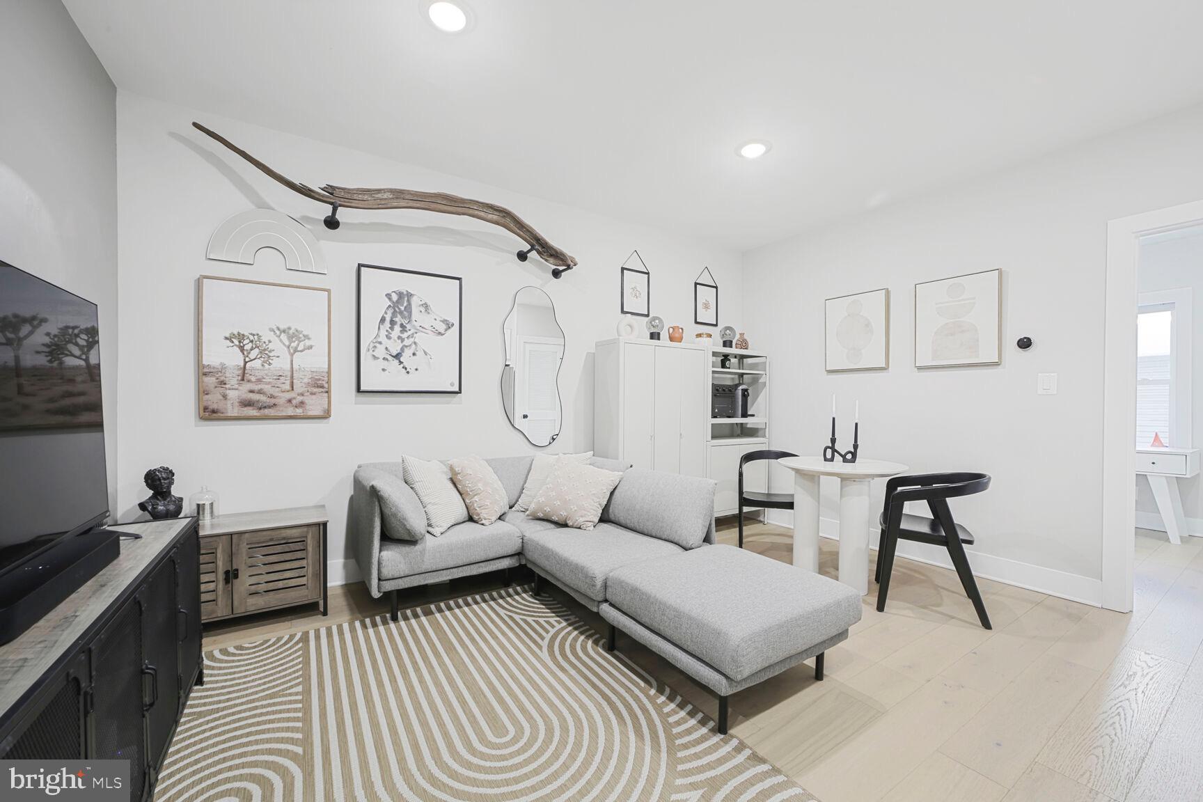 1144 Owen Place Northeast, Unit 1 Washington, DC 20002 - Photo 10 of 27 a living room with furniture and a rug