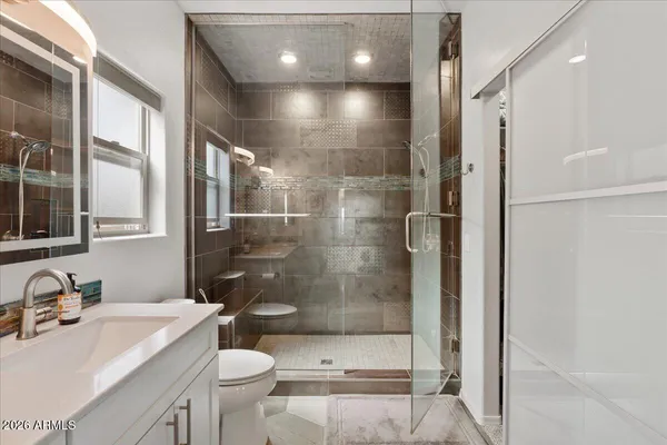 a bathroom with a sink toilet and shower