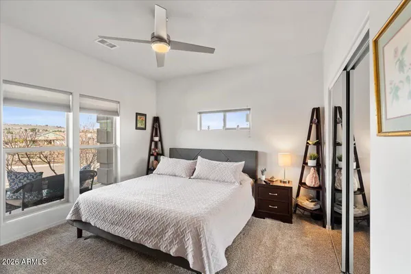 a bedroom with a bed and a large window