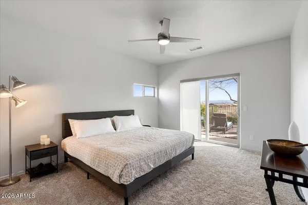 a bedroom with a large bed and a chandelier
