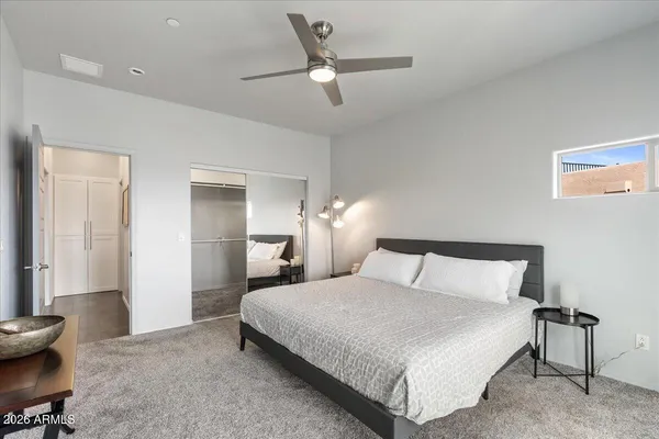 a bedroom with a bed and a chandelier