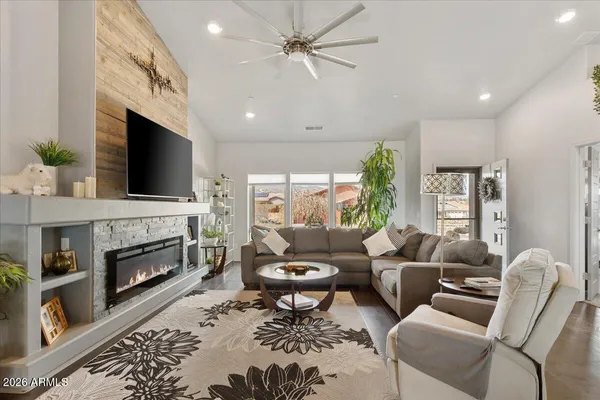 a living room with furniture a fireplace and a flat screen tv