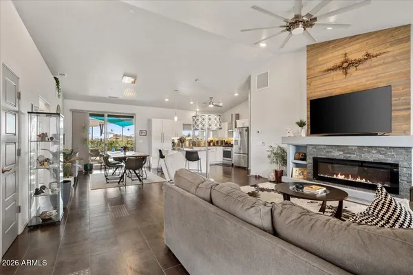 a living room with furniture a fireplace and a flat screen tv