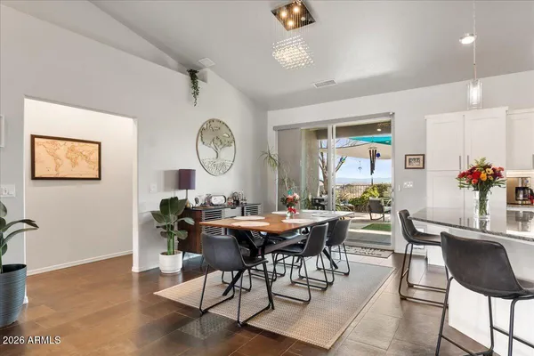 a view of a dining room and livingroom furniture and a large window