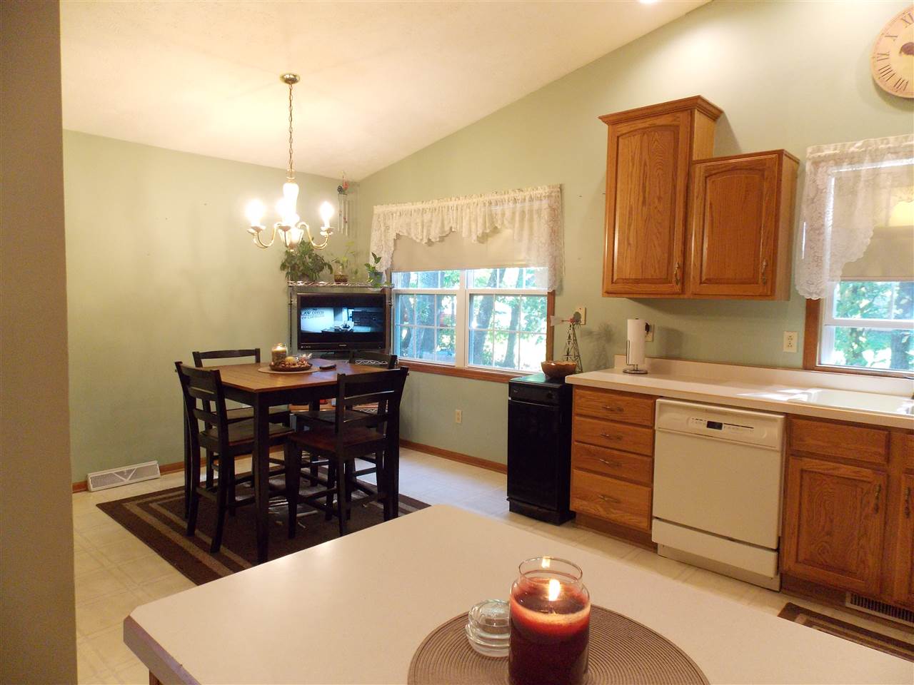 478 Marstonmoor Road Davis, IL 61019 - Photo 3 of 25 a kitchen with stainless steel appliances a dining table a sink dishwasher and a fireplace with wooden floor