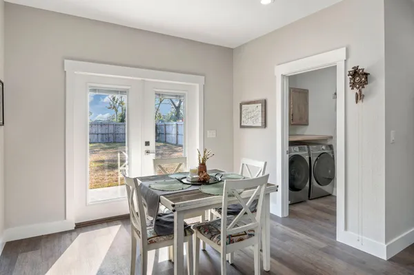 a dining room with furniture and wooden floor