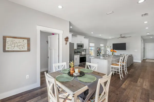 a view of a dining room with furniture and wooden floor
