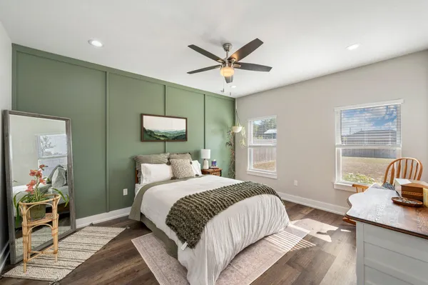 a bedroom with a bed and a chandelier