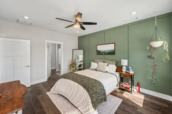 a bedroom with a bed and a mirror