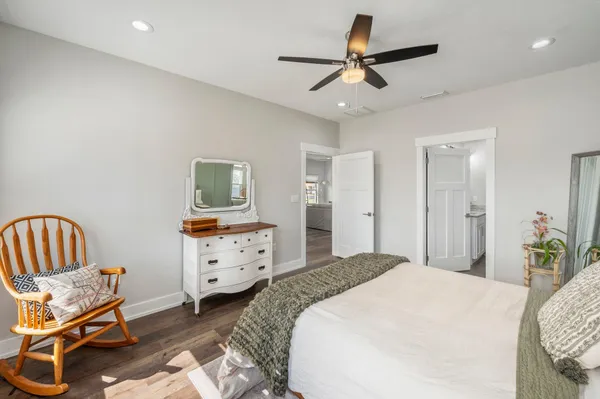 a bedroom with a bed and a chair