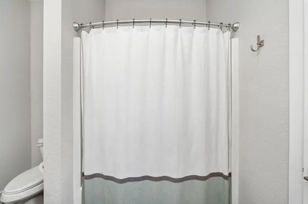 a bathroom with a shower curtain and sink