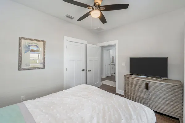 a bedroom with a bed and a flat screen tv