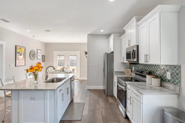 a kitchen with stainless steel appliances a sink stove and refrigerator