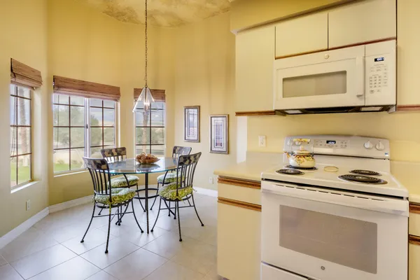a bedroom with a bed and teddy bear on bed