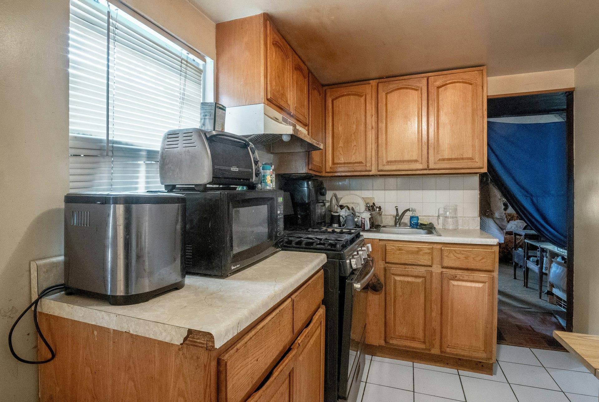 127 B Edgewater Park, Unit B Bronx, NY 10465 - Photo 4 of 26 a kitchen with stainless steel appliances granite countertop a sink a stove and a refrigerator