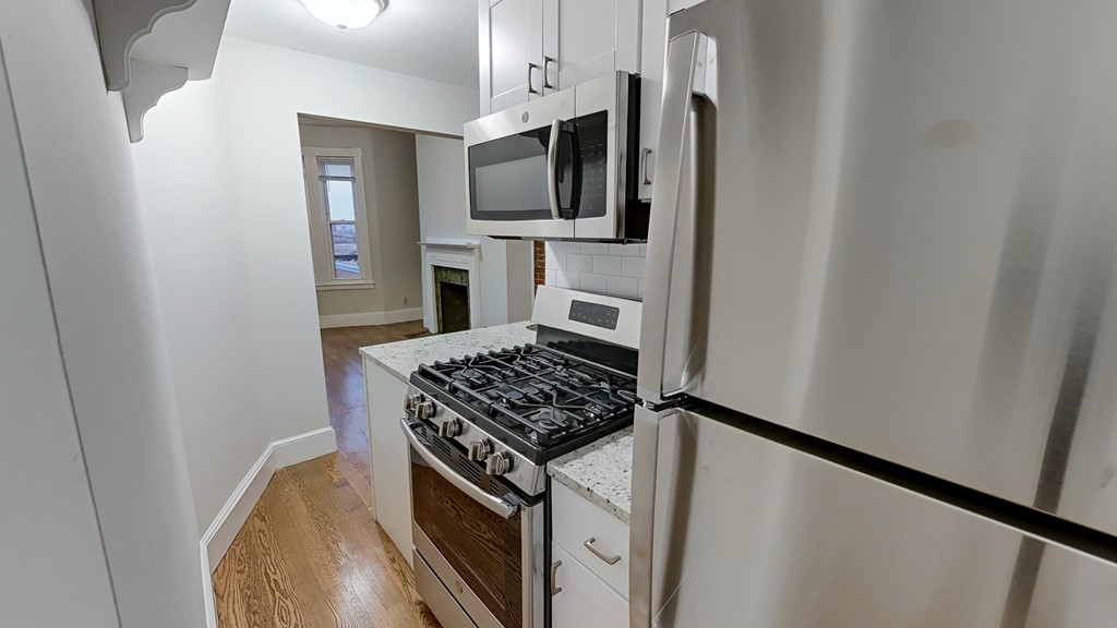 a kitchen with stainless steel appliances a refrigerator a stove top oven a sink and dishwasher