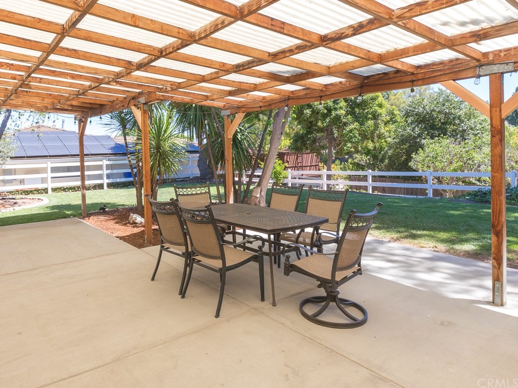 64 Ranchview Road Rolling Hills Estates, CA 90274 - Photo 22 of 38 a view of a patio with a table chairs and a backyard