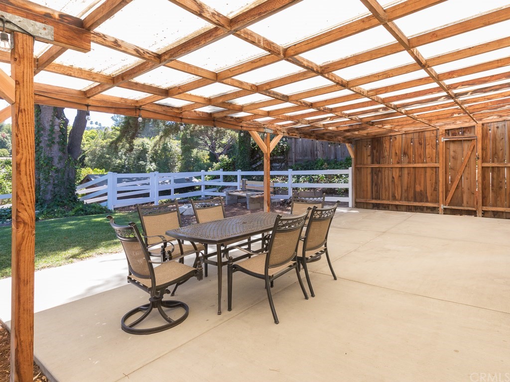 64 Ranchview Road Rolling Hills Estates, CA 90274 - Photo 24 of 38 a view of patio with table and chairs with wooden floor and fence