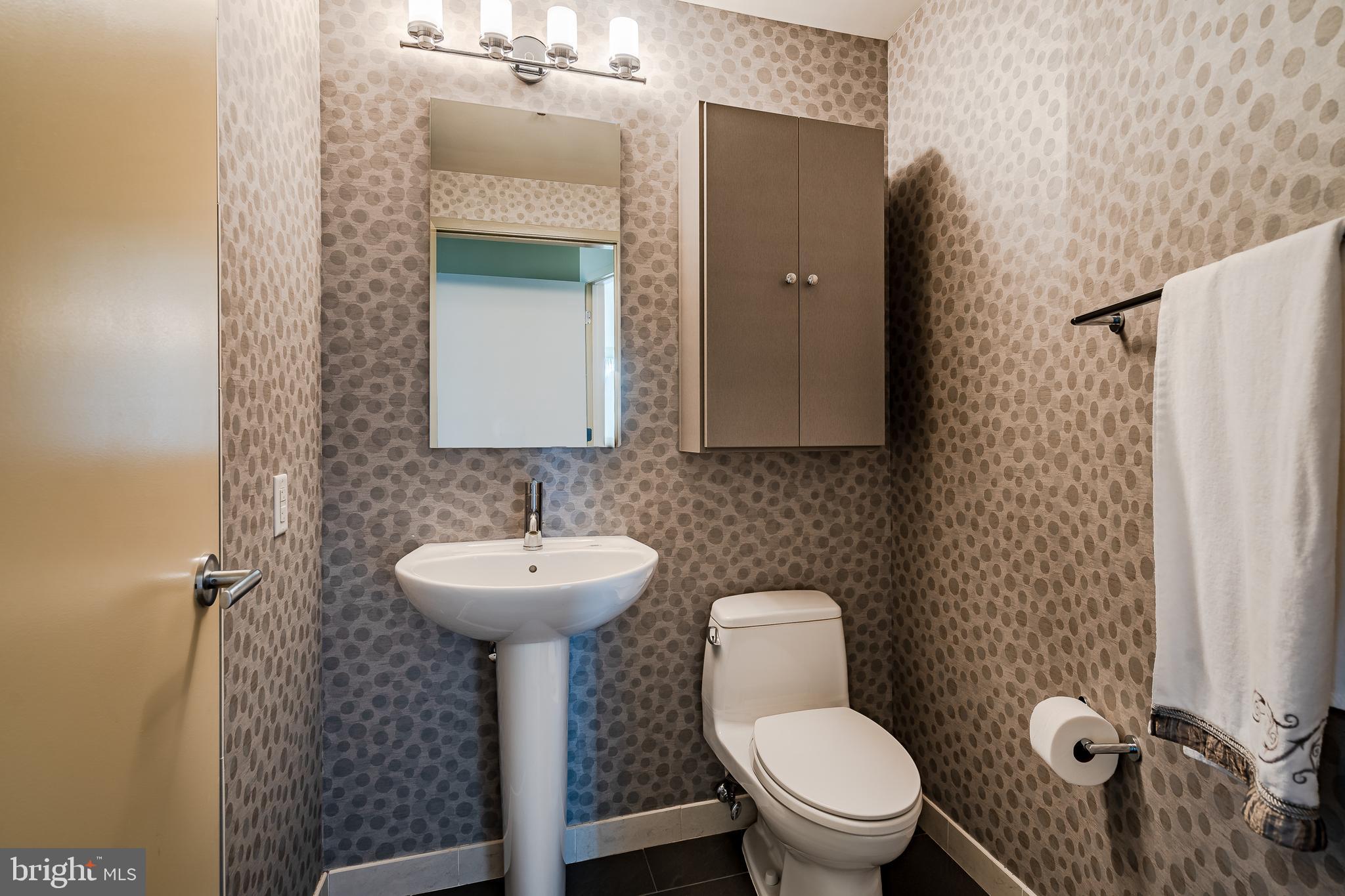 2101-00 Market Street, Unit 1803 Philadelphia, PA 19103 - Photo 23 of 52 a bathroom with a sink toilet and a mirror