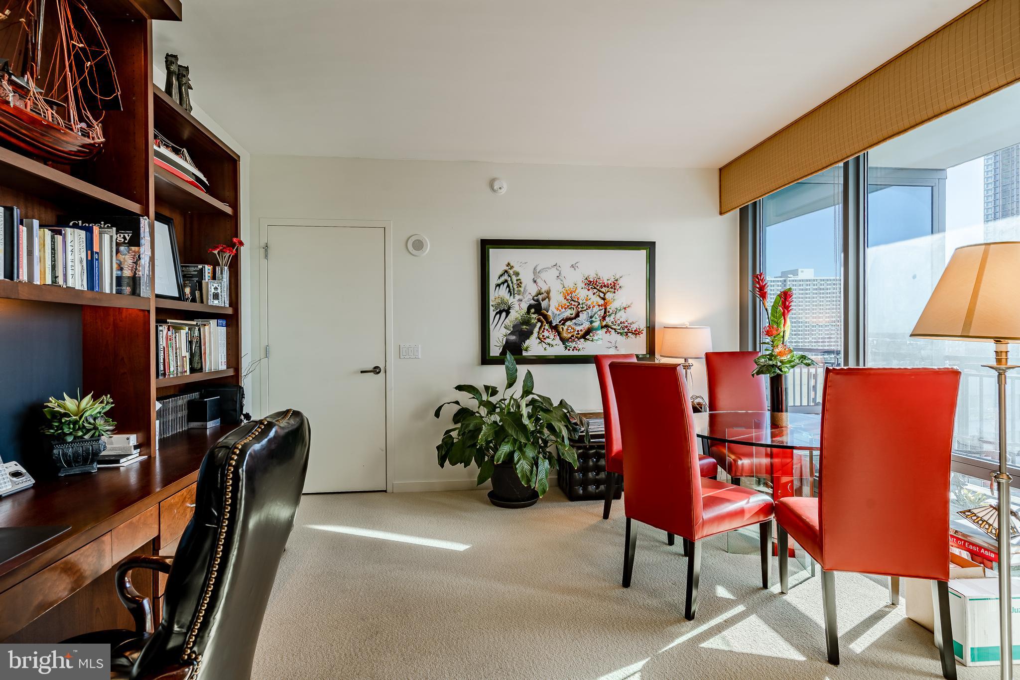 2101-00 Market Street, Unit 1803 Philadelphia, PA 19103 - Photo 28 of 52 a dining room with furniture and a potted plant
