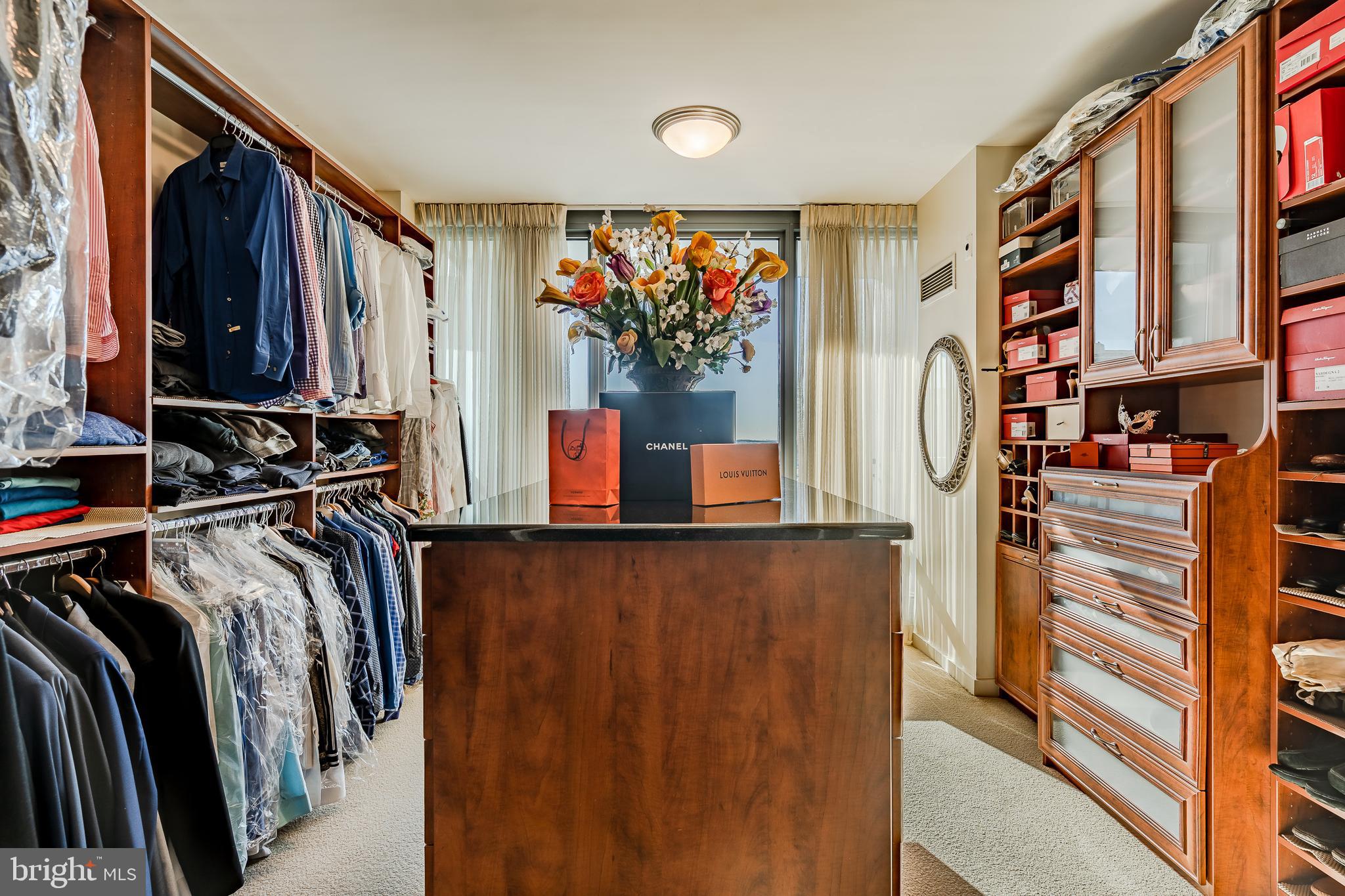 2101-00 Market Street, Unit 1803 Philadelphia, PA 19103 - Photo 36 of 52 a view of walk in closet with clothes and shoes