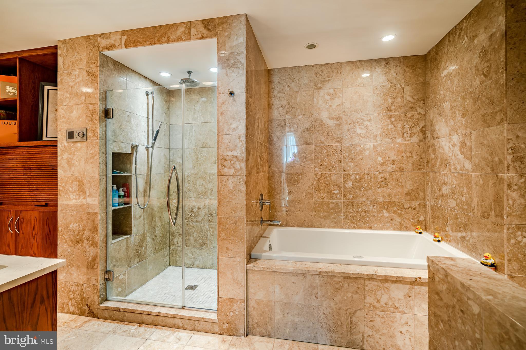 2101-00 Market Street, Unit 1803 Philadelphia, PA 19103 - Photo 38 of 52 a bathroom with a bathtub and a shower