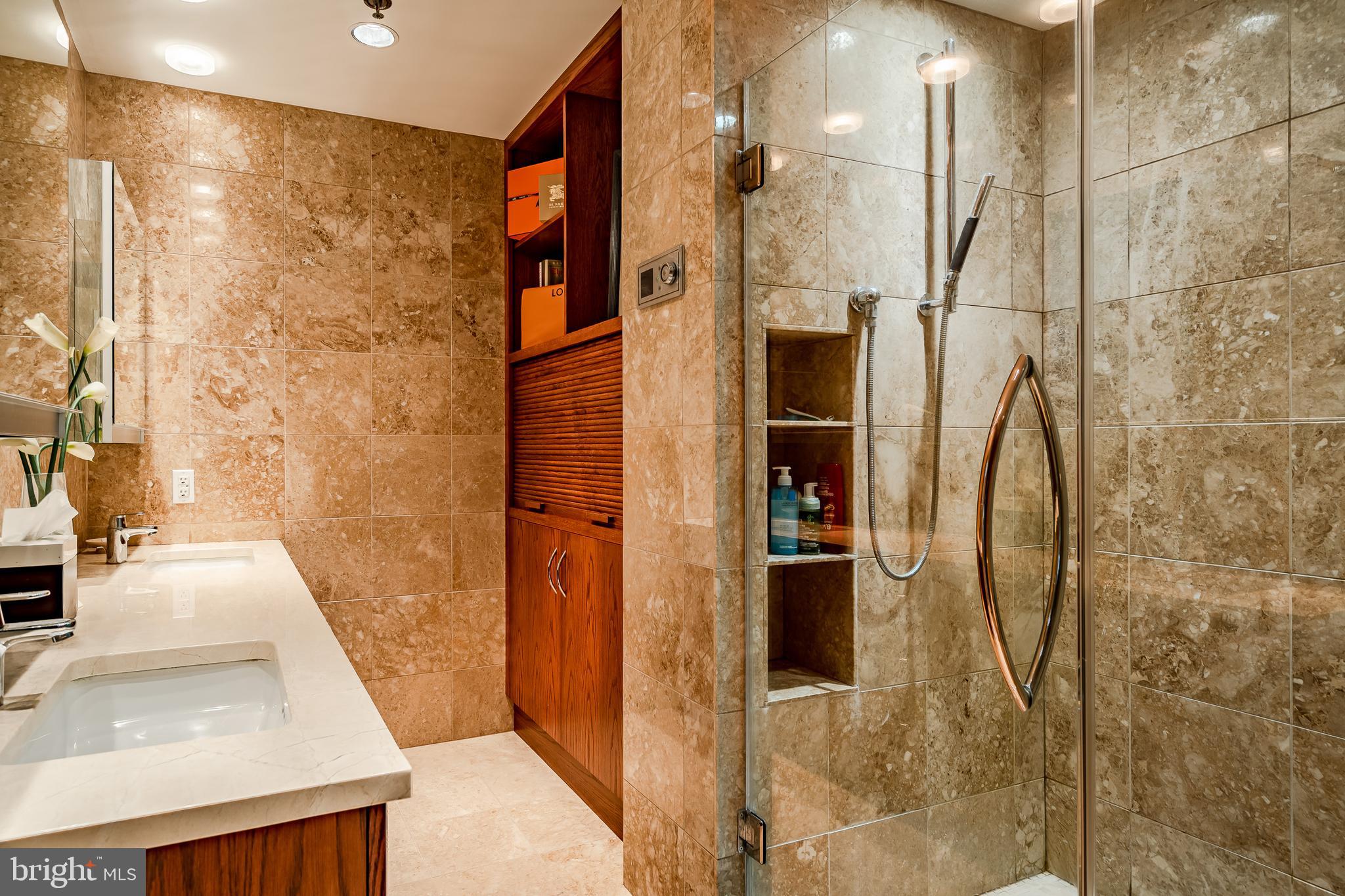 2101-00 Market Street, Unit 1803 Philadelphia, PA 19103 - Photo 39 of 52 a bathroom with a sink and shower