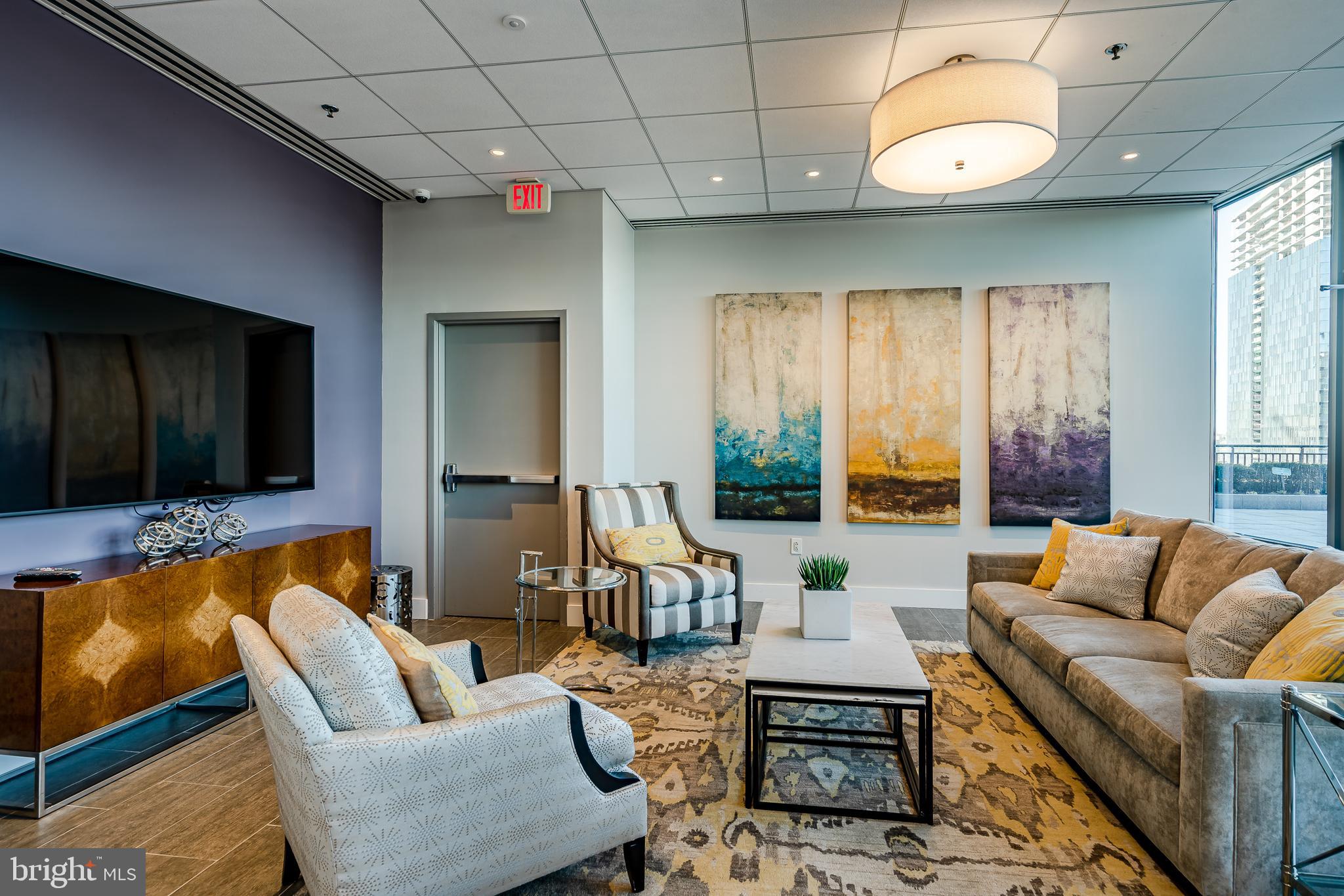 2101-00 Market Street, Unit 1803 Philadelphia, PA 19103 - Photo 46 of 52 a living room with furniture a large window and a flat screen tv