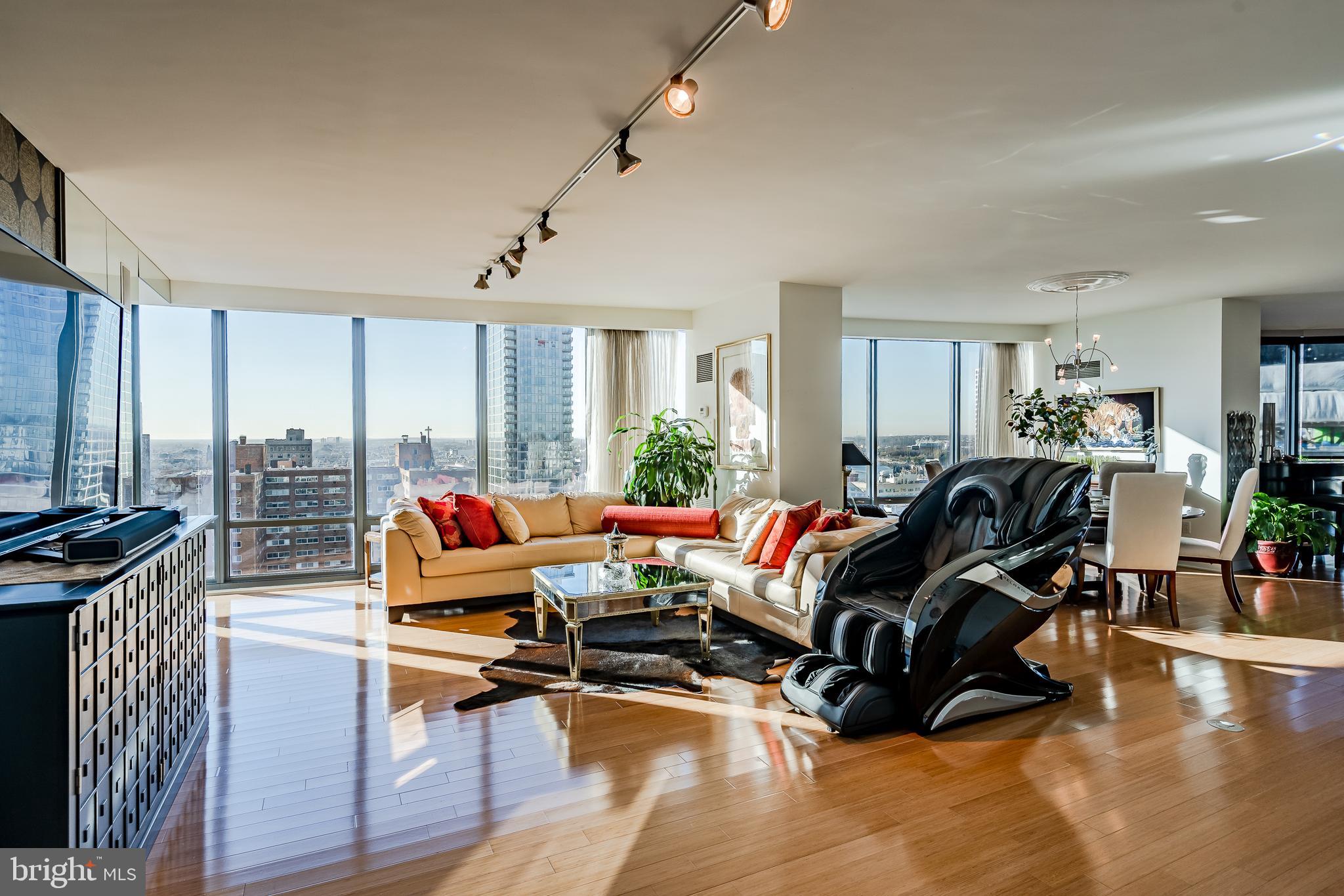 2101-00 Market Street, Unit 1803 Philadelphia, PA 19103 - Photo 5 of 52 a living room with furniture window and wooden floor