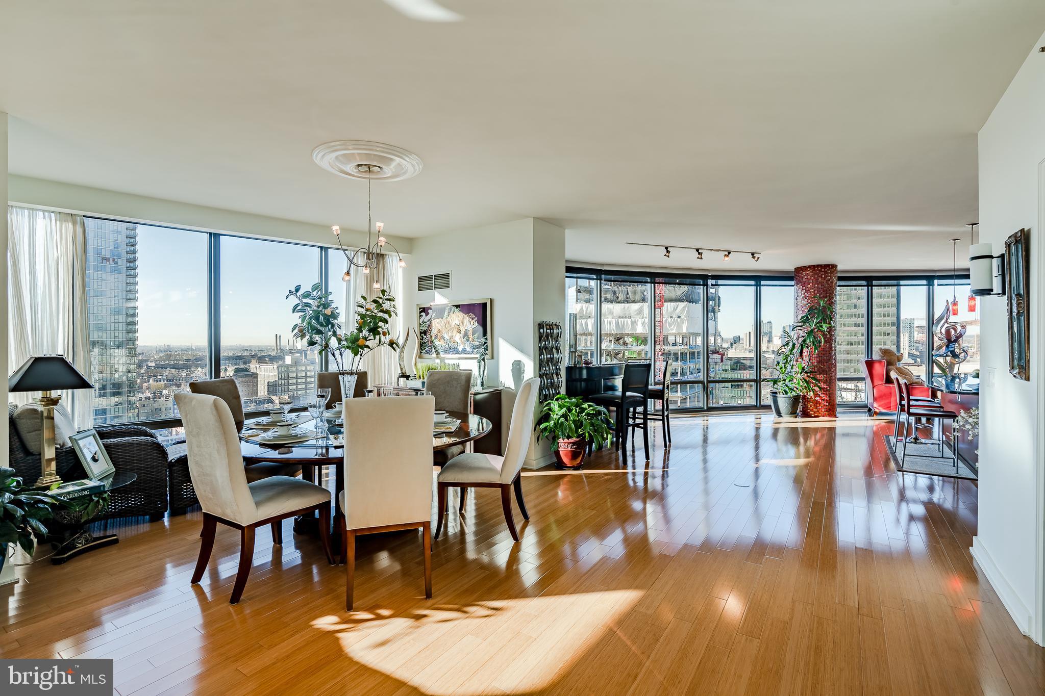 2101-00 Market Street, Unit 1803 Philadelphia, PA 19103 - Photo 9 of 52 a view of a dining room and livingroom with lots of furniture wooden floor and a rug
