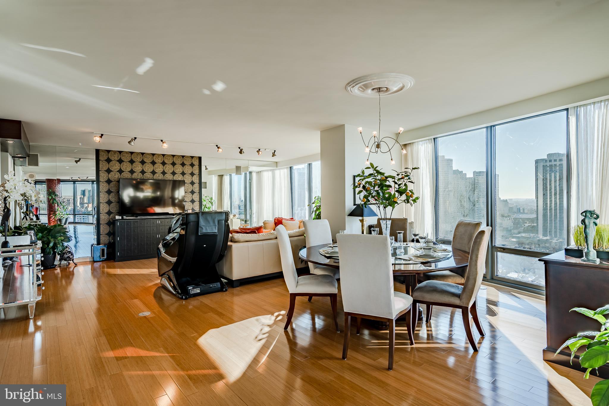 2101-00 Market Street, Unit 1803 Philadelphia, PA 19103 - Photo 10 of 52 a dining room with furniture potted plants and wooden floor