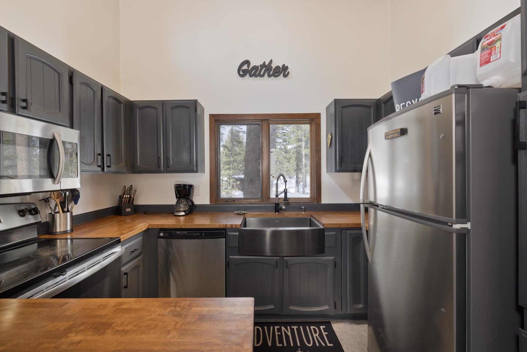 3005 Meridian Boulevard, Unit 47 Mammoth Lakes, CA 93546 - Photo 12 of 40 a kitchen with stainless steel appliances a refrigerator a sink a stove a microwave and cabinets