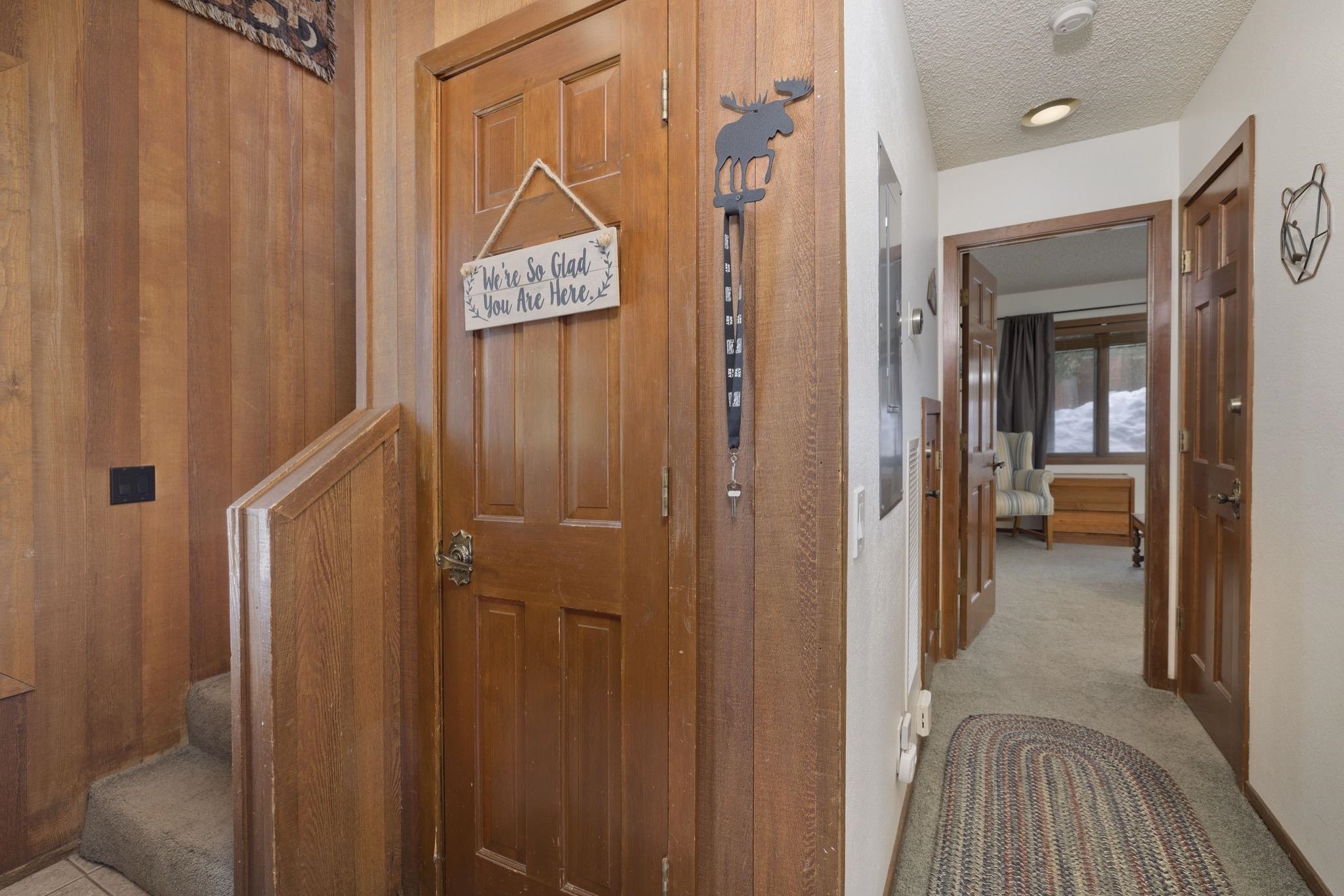 3005 Meridian Boulevard, Unit 47 Mammoth Lakes, CA 93546 - Photo 18 of 40 a view of a hallway with wooden floor and bathroom view