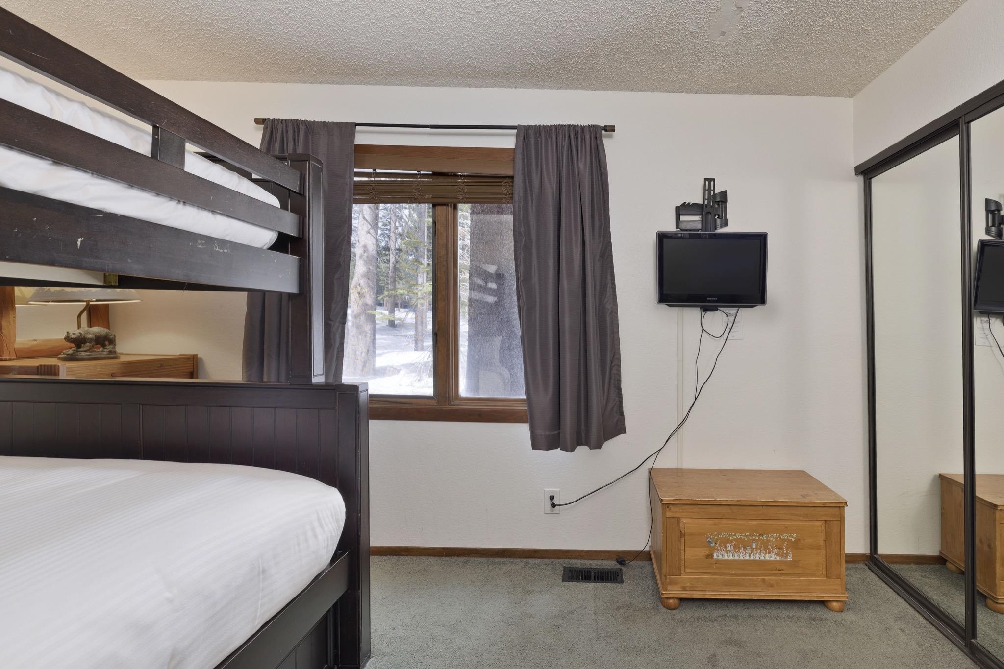 3005 Meridian Boulevard, Unit 47 Mammoth Lakes, CA 93546 - Photo 21 of 40 a bedroom with a bed and a flat tv screen