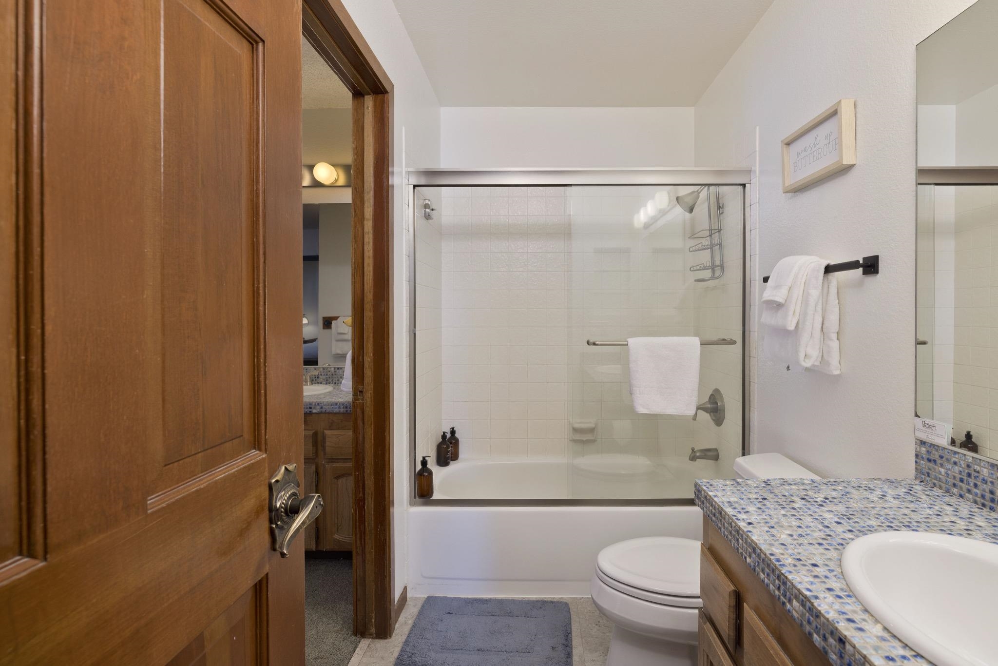 3005 Meridian Boulevard, Unit 47 Mammoth Lakes, CA 93546 - Photo 22 of 40 a bathroom with a granite countertop toilet sink and shower
