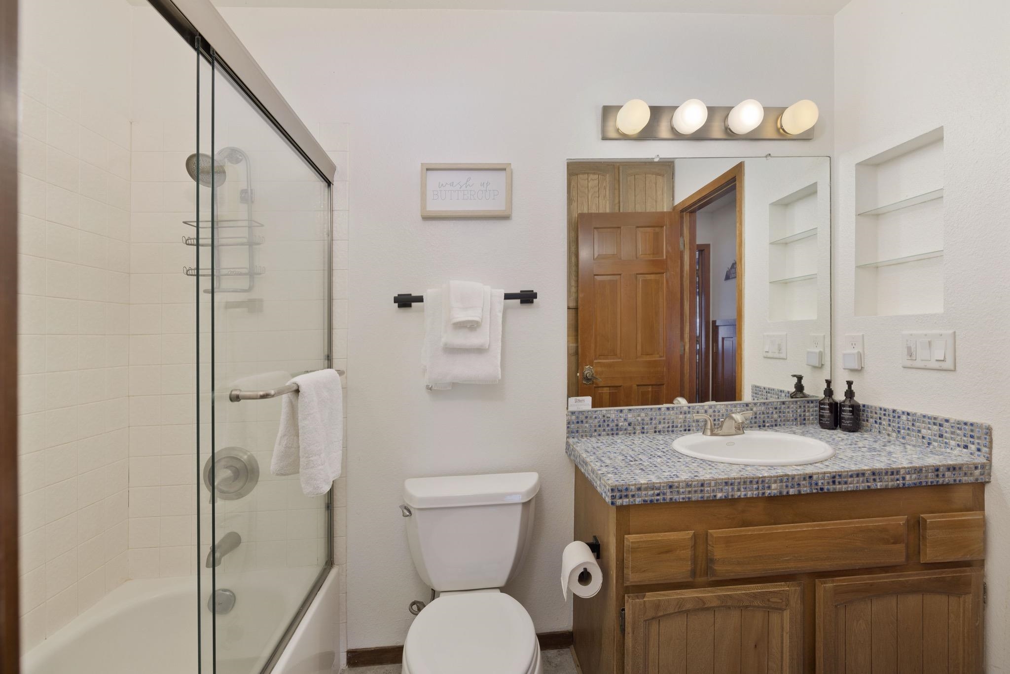 3005 Meridian Boulevard, Unit 47 Mammoth Lakes, CA 93546 - Photo 23 of 40 a bathroom with a granite countertop sink toilet and shower