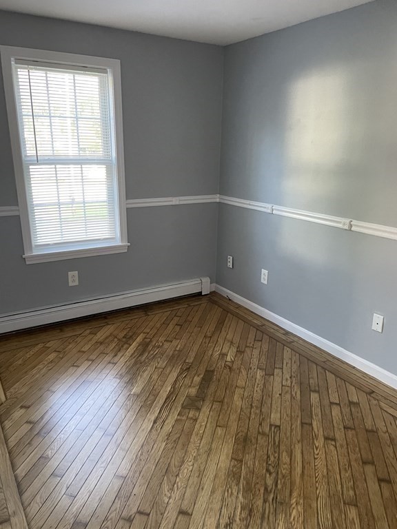 13 Ledge Road Norton, MA 02766 - Photo 12 of 22 an empty room with wooden floor and windows