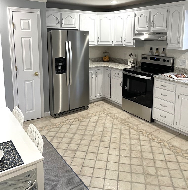 13 Ledge Road Norton, MA 02766 - Photo 4 of 22 a kitchen with stainless steel appliances a refrigerator sink and cabinets