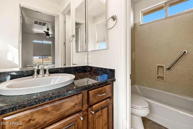 a view of a lake with a bench in front of house