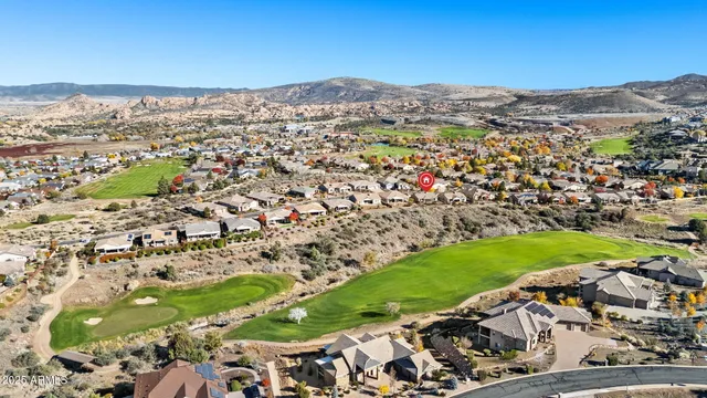 an aerial view of residential houses with outdoor space and street view
