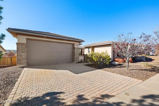 a front view of a house with outdoor seating