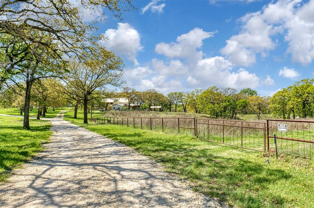 247 Private Road Covington, TX 76636 - Photo 6 of 38 View of community with fence and a lawn