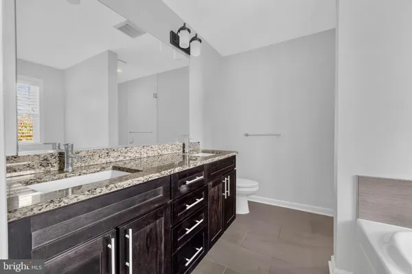 a bathroom with a bathtub and sink