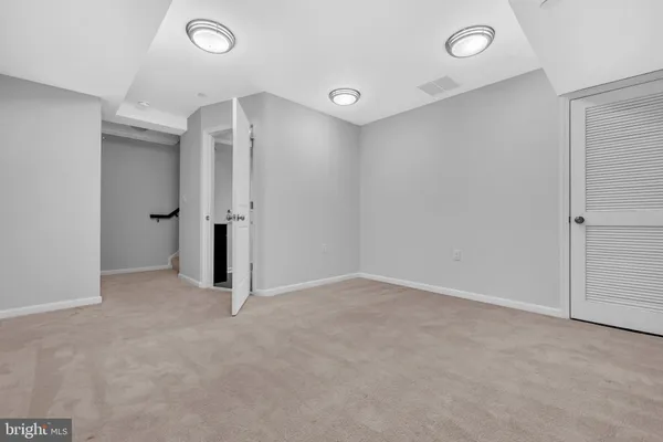 a bathroom with a sink a toilet and a light fixture