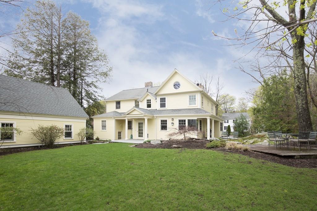 7 Locust Road Weston, MA 02493 - Photo 13 of 13 a front view of a house with a garden and trees