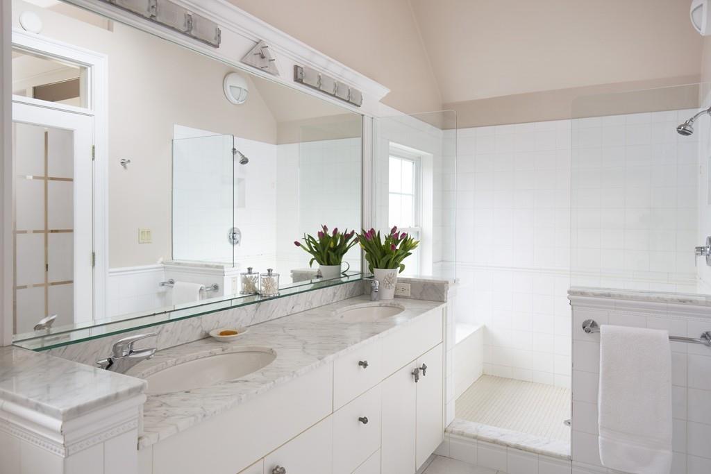 7 Locust Road Weston, MA 02493 - Photo 7 of 13 a bathroom with a sink and mirror with bathtub